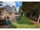 This lovely backyard has a well maintained lawn, a privacy fence, and a charming deck area at 9975 Groomsbridge Rd, Johns Creek, GA 30022