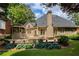 The backyard boasts a spacious deck area and well-maintained lawn, perfect for outdoor gatherings and relaxation at 9975 Groomsbridge Rd, Johns Creek, GA 30022