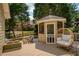 Deck with an egg chair, a gazebo, and a view of a fenced backyard and house at 9975 Groomsbridge Rd, Johns Creek, GA 30022