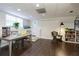 Finished basement with a gray table, chairs, wicker chair, and a bookshelf at 9975 Groomsbridge Rd, Johns Creek, GA 30022