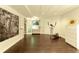 Finished basement showing wood floors, exercise equipment, and white trim at 9975 Groomsbridge Rd, Johns Creek, GA 30022