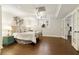 Finished basement featuring wood floors, a bedroom area, and white trim at 9975 Groomsbridge Rd, Johns Creek, GA 30022