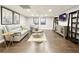 Finished basement showing wood floors, neutral walls, and a seating area at 9975 Groomsbridge Rd, Johns Creek, GA 30022