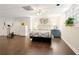 Finished basement displaying wood floors, a bedroom area, and exercise equipment at 9975 Groomsbridge Rd, Johns Creek, GA 30022