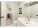 Bright bathroom featuring a toilet, vanity with mirror, and neutral wall tones at 9975 Groomsbridge Rd, Johns Creek, GA 30022