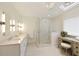 Bathroom featuring double sink vanity, glass shower, and stylish light fixtures at 9975 Groomsbridge Rd, Johns Creek, GA 30022