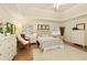 Bright bedroom with tray ceiling, large windows, plush carpet, and neutral decor creates a serene and inviting space at 9975 Groomsbridge Rd, Johns Creek, GA 30022