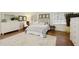 Cozy bedroom with neutral decor, white furniture, and wood flooring at 9975 Groomsbridge Rd, Johns Creek, GA 30022