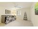 Bedroom showcasing a twin bed, ceiling fan, neutral walls, and a window with natural light at 9975 Groomsbridge Rd, Johns Creek, GA 30022