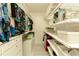 Spacious walk-in closet with custom shelving and hanging racks provides ample storage for clothing and accessories at 9975 Groomsbridge Rd, Johns Creek, GA 30022
