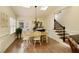 Sunny dining room with skylights, wood floors, and a chandelier over the wooden table at 9975 Groomsbridge Rd, Johns Creek, GA 30022