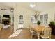 Sunlit dining room with hardwood floors, views to the living room and views to the backyard at 9975 Groomsbridge Rd, Johns Creek, GA 30022