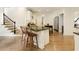 Bright kitchen with granite countertops, white cabinetry, stainless appliances, and hardwood floors at 9975 Groomsbridge Rd, Johns Creek, GA 30022