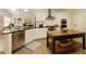 Modern kitchen with white cabinets, granite countertops, stainless steel appliances, and a center island at 9975 Groomsbridge Rd, Johns Creek, GA 30022