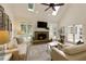 Inviting living room with a fireplace and doors leading to the backyard at 9975 Groomsbridge Rd, Johns Creek, GA 30022
