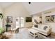 Bright living room with hardwood floors, a comfortable sofa, and access to the outdoors at 9975 Groomsbridge Rd, Johns Creek, GA 30022