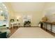 Inviting living room featuring a large window, hardwood floors, and neutral decor at 9975 Groomsbridge Rd, Johns Creek, GA 30022