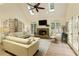 Living room with skylights, fireplace, and doors leading to the outside at 9975 Groomsbridge Rd, Johns Creek, GA 30022