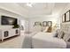 Main bedroom with tray ceiling, white furnishings, and light, neutral decor at 9975 Groomsbridge Rd, Johns Creek, GA 30022