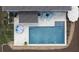 Aerial shot of a backyard with a pool, travertine patio, lounge chairs, and a cozy seating area at 244 Citrine Way, Acworth, GA 30101