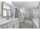 Modern bathroom featuring double vanities, a soaking tub, a shower, and blue walls at 244 Citrine Way, Acworth, GA 30101