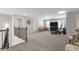 Expansive bonus room area with a railing, neutral walls, and space for exercise equipment and recreation at 244 Citrine Way, Acworth, GA 30101