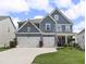 Charming two-story home with a two-car garage, landscaped yard, and welcoming front porch at 244 Citrine Way, Acworth, GA 30101