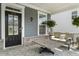 Inviting front porch with a comfortable seating area and decorative potted plants at 244 Citrine Way, Acworth, GA 30101