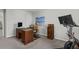 Well-lit home office featuring a wooden desk, comfortable chair, filing cabinet, and a beach themed art piece at 244 Citrine Way, Acworth, GA 30101
