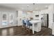 Bright kitchen with stainless steel appliances, island with seating, and access to outdoor pool area at 244 Citrine Way, Acworth, GA 30101