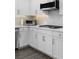 Kitchen detail featuring white cabinets, quartz countertops, and stainless steel appliances at 244 Citrine Way, Acworth, GA 30101