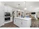 Open concept kitchen with island and stainless appliances, flowing into living area at 244 Citrine Way, Acworth, GA 30101