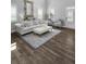 Spacious living room showcasing hardwood floors, stylish furniture, and large windows at 244 Citrine Way, Acworth, GA 30101