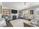 Comfortable living room with built-in shelving, fireplace, and large windows with plantation shutters at 244 Citrine Way, Acworth, GA 30101