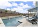 Backyard oasis with a refreshing pool, decorative water feature, landscaping, and outdoor lounge furniture at 244 Citrine Way, Acworth, GA 30101