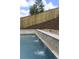 Beautiful backyard pool with a decorative water feature, surrounded by lush landscaping at 244 Citrine Way, Acworth, GA 30101