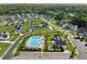 Aerial view of community pool and clubhouse, showcasing the neighborhood's recreational amenities and manicured landscaping at 7420 Wild Violet Dr, Cumming, GA 30040