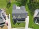 Aerial view of a modern home with manicured lawn, complemented by a sleek driveway and stylish landscaping at 7420 Wild Violet Dr, Cumming, GA 30040