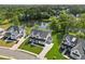 Aerial view of elegant modern homes with manicured lawns, showcasing the neighborhood's appeal and serene lakeside at 7420 Wild Violet Dr, Cumming, GA 30040
