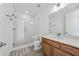 Modern bathroom features a vanity with a sink, a toilet, and a glass-enclosed shower with tile surround at 7420 Wild Violet Dr, Cumming, GA 30040