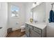 Stylish powder room featuring a modern vanity and a window for natural light at 7420 Wild Violet Dr, Cumming, GA 30040