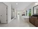 Expansive bathroom with a glass-enclosed shower, a soaking tub, dual vanities, and ample natural light at 7420 Wild Violet Dr, Cumming, GA 30040