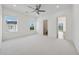 Spacious bedroom with bright carpet, large windows, and a connected bath provides a comfortable and serene living space at 7420 Wild Violet Dr, Cumming, GA 30040