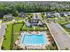 Aerial view of community pool and clubhouse, showcasing the neighborhood's recreational amenities and manicured landscaping at 7420 Wild Violet Dr, Cumming, GA 30040