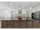 Gourmet kitchen with large island, modern appliances, and pendant lighting at 7420 Wild Violet Dr, Cumming, GA 30040