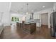 Open kitchen featuring a large island, stainless steel appliances, and modern design at 7420 Wild Violet Dr, Cumming, GA 30040