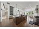 Modern kitchen with a large island, stainless steel appliances, and an open floor plan in a brightly lit living area at 7420 Wild Violet Dr, Cumming, GA 30040