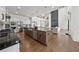Spacious, open-concept kitchen boasts a large island, stainless appliances, and seamless flow into the dining and living areas at 7420 Wild Violet Dr, Cumming, GA 30040