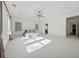 Open main bedroom with tray ceiling, large windows, and neutral carpet, providing ample space and natural light at 7420 Wild Violet Dr, Cumming, GA 30040
