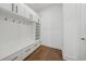 Well-organized mudroom with custom built-in shelving, hooks, bench, and storage cabinets for convenient entryway organization at 7420 Wild Violet Dr, Cumming, GA 30040